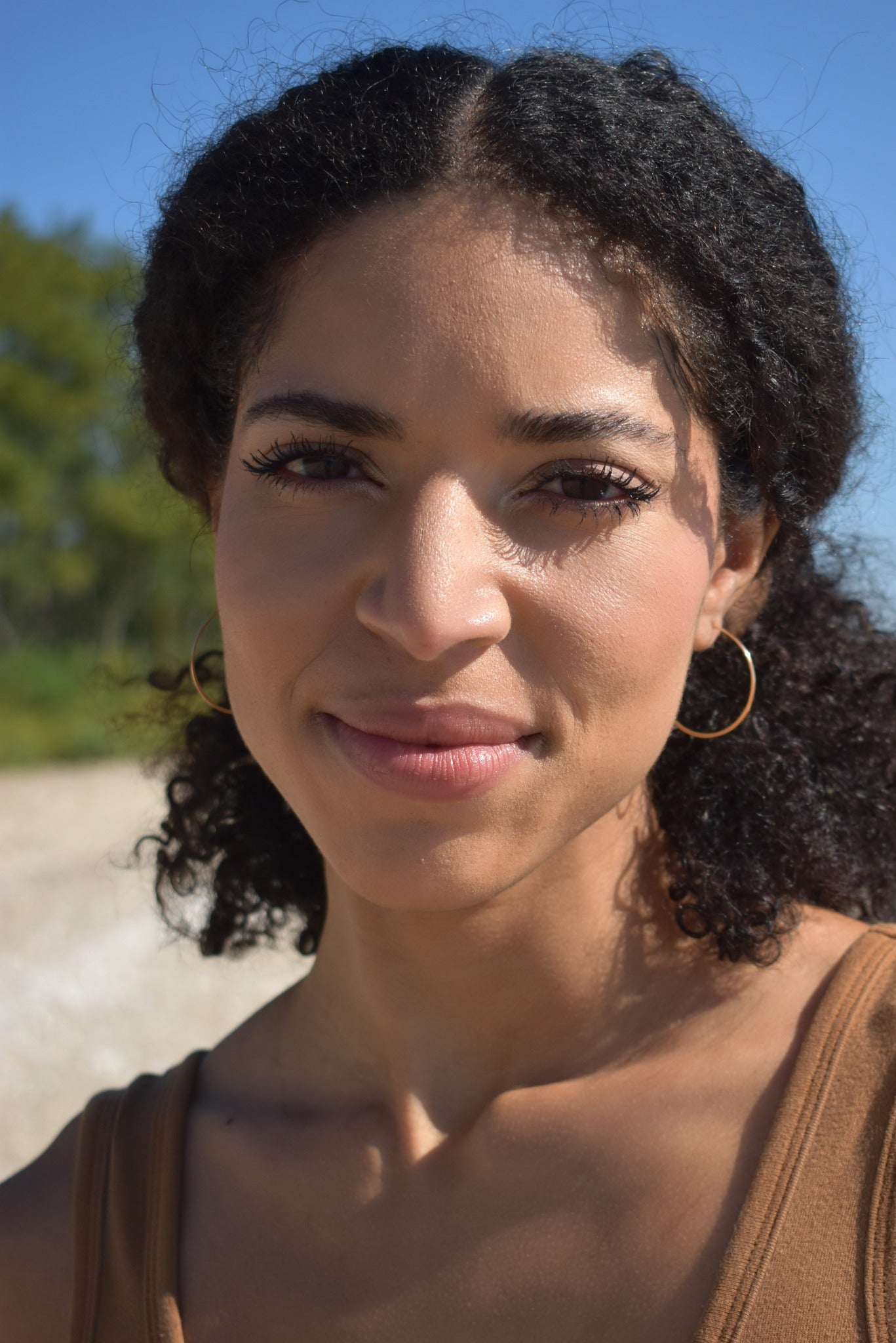 Thin handmade hammered gold hoop on model