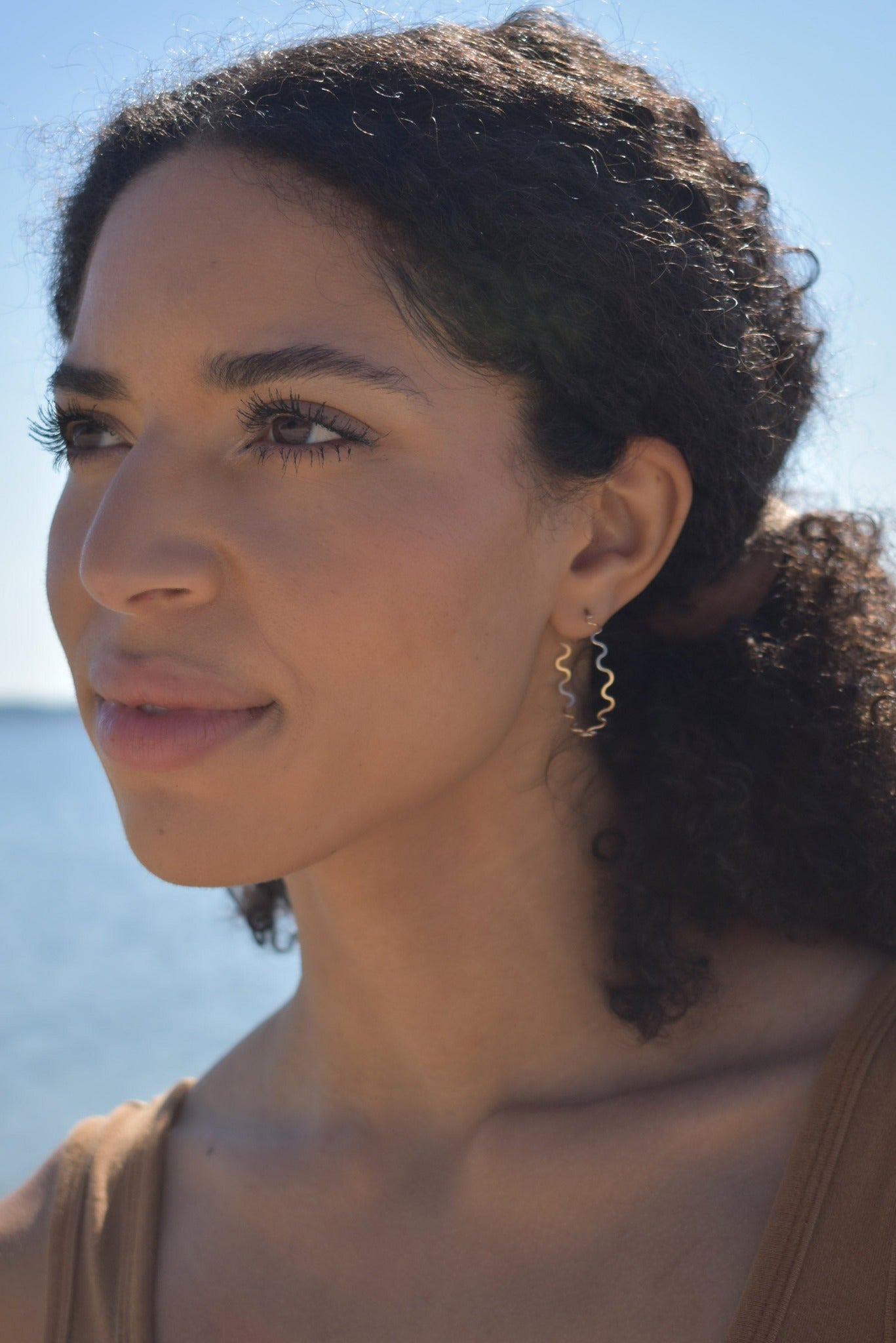 Curvy thin hand formed hammered gold hoops