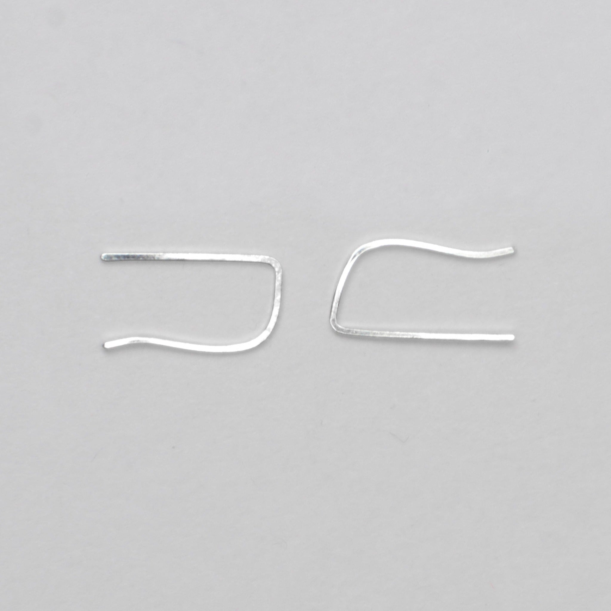 silver ear bars on grey background