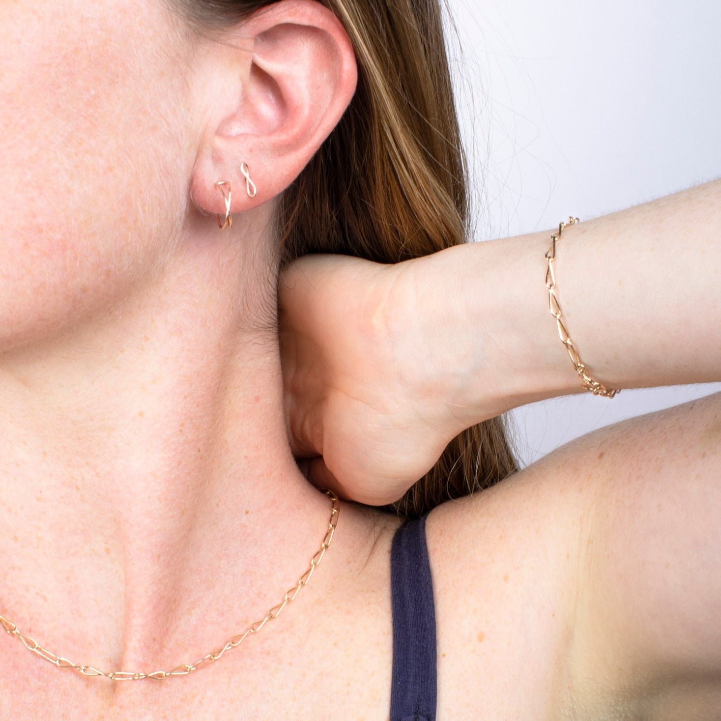 model wearing 14k gold fill handmade chain necklace, bracelet and earrings