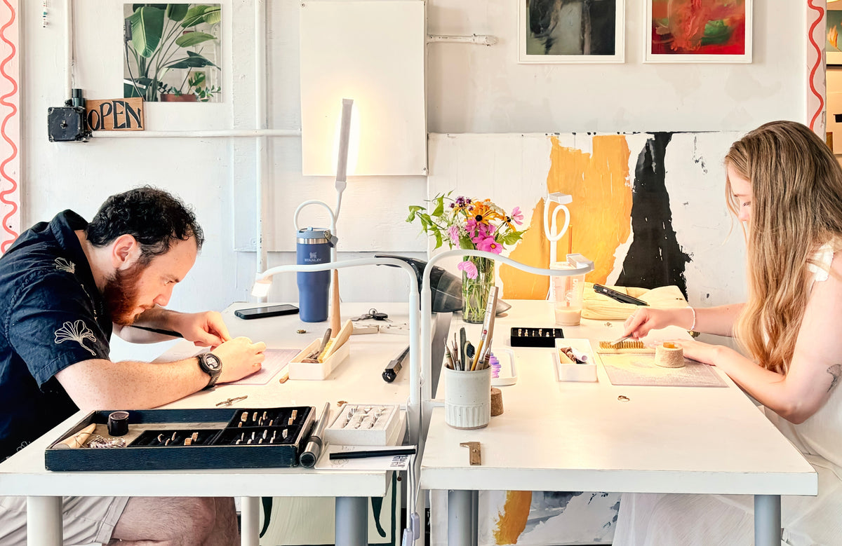 Couple carving their wax wedding bands together at the RA HA Providence studio