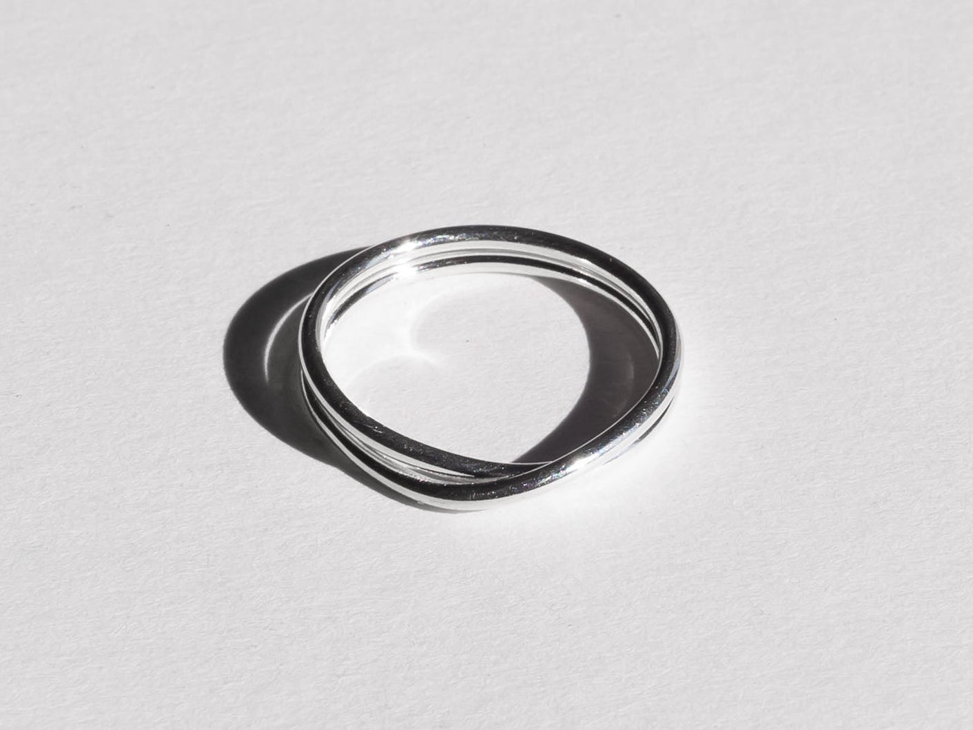 Silver ring on a light gray background