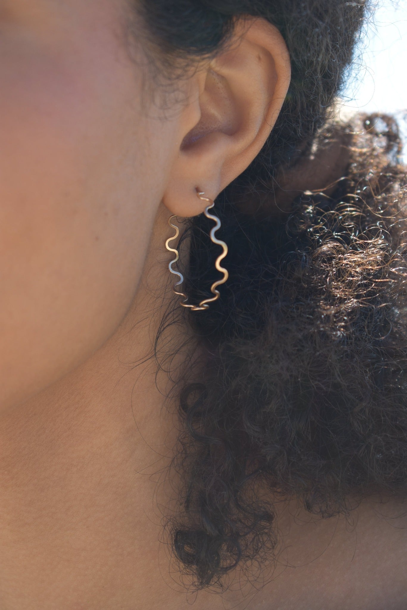 Curved thin hand formed hammered gold hoops