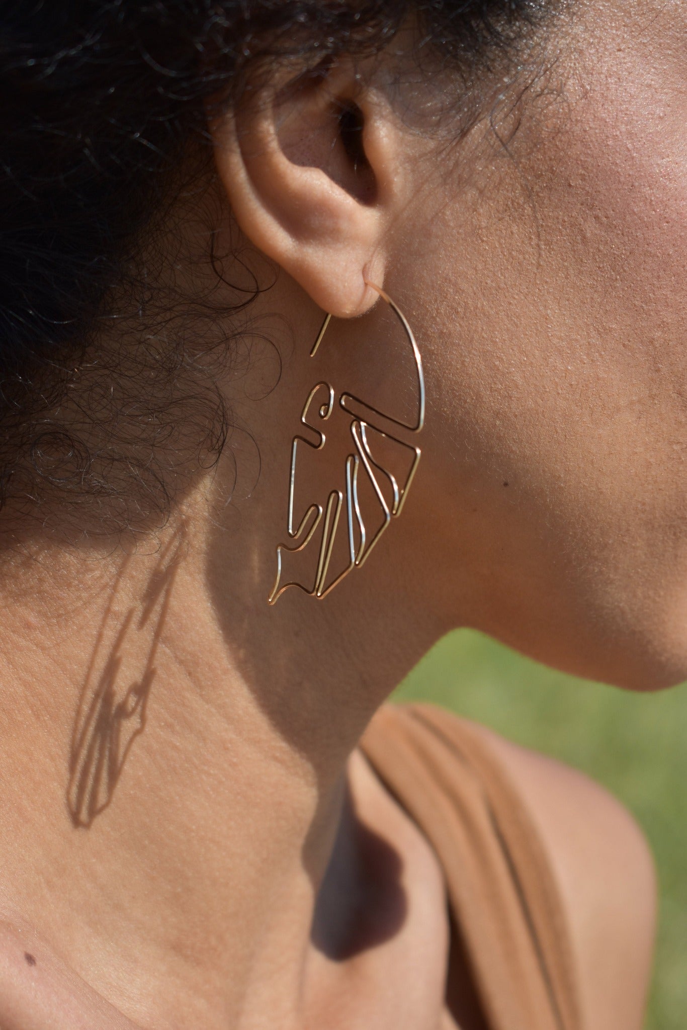 Hand formed sculptural wire earrings inspired by the monstera plant leaf