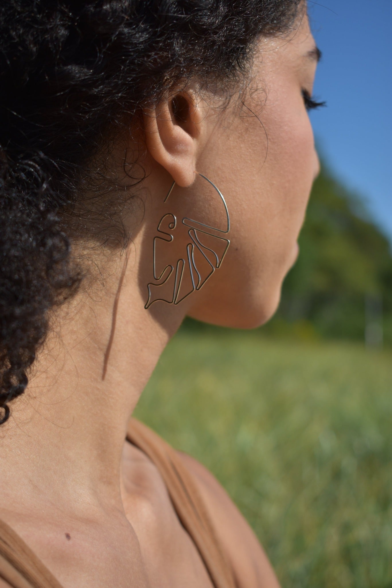 Hand formed sculptural wire earrings inspired by the monstera plant leaf