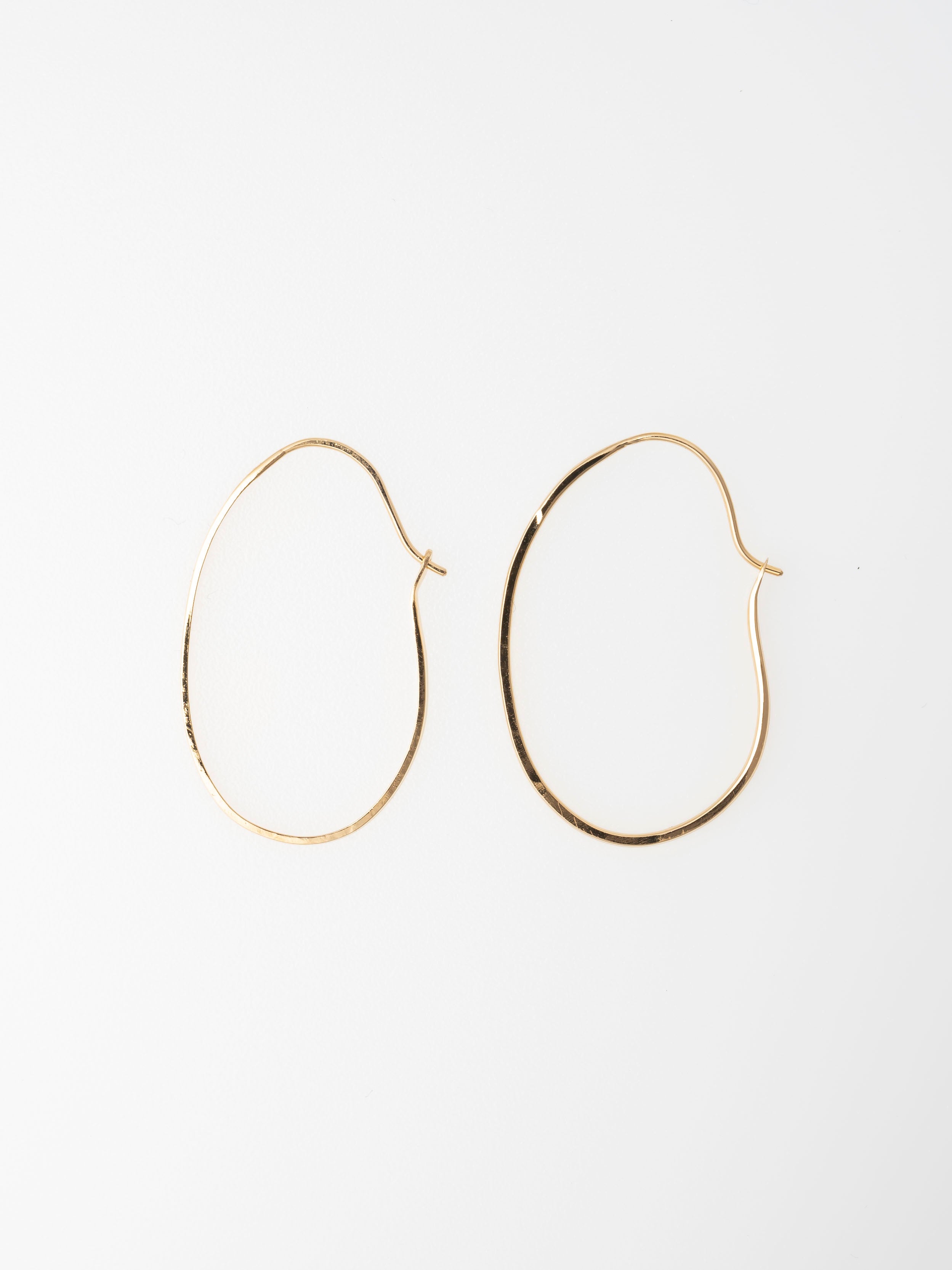 Gold hoop earrings on a white background