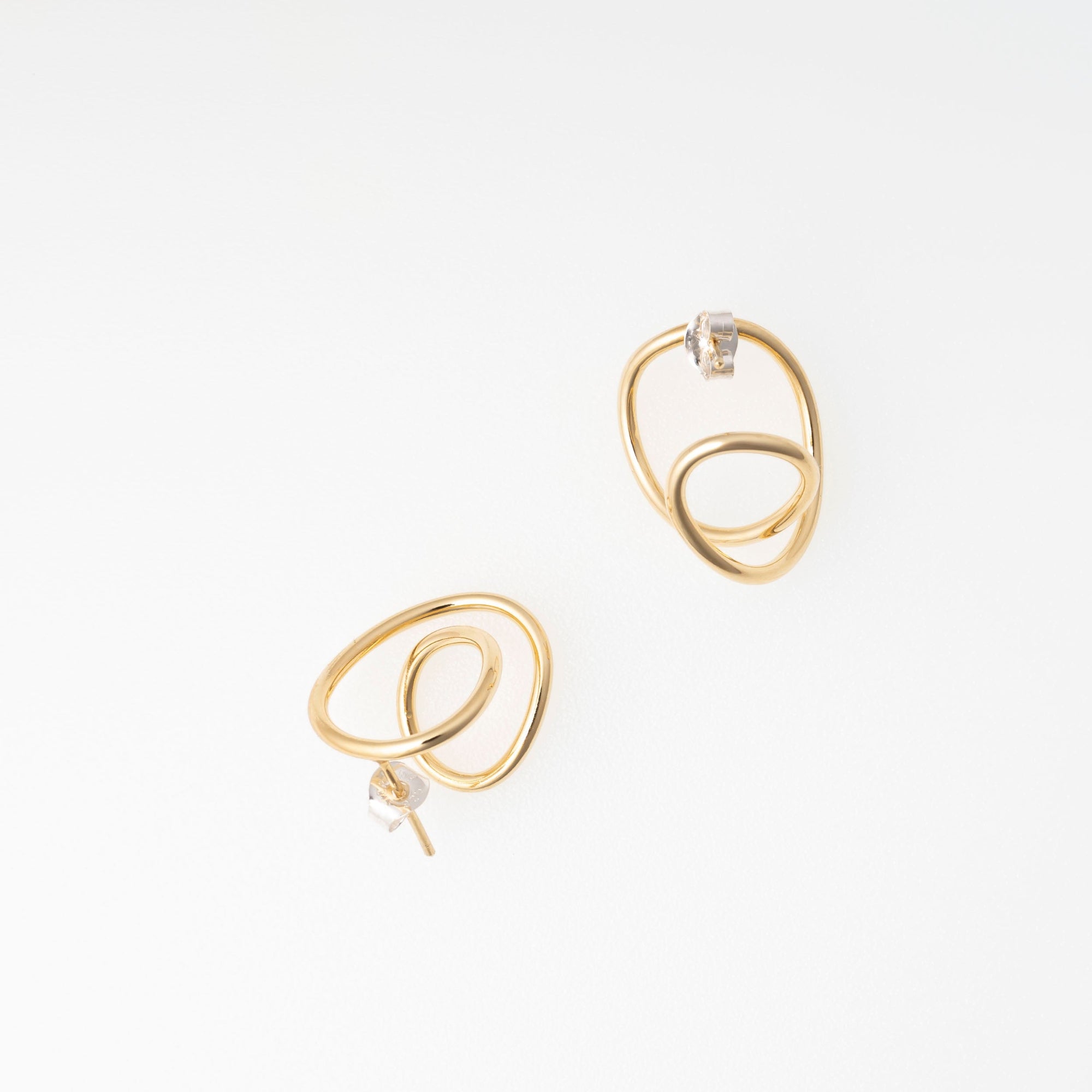 Pair of gold spiral earrings on a white background