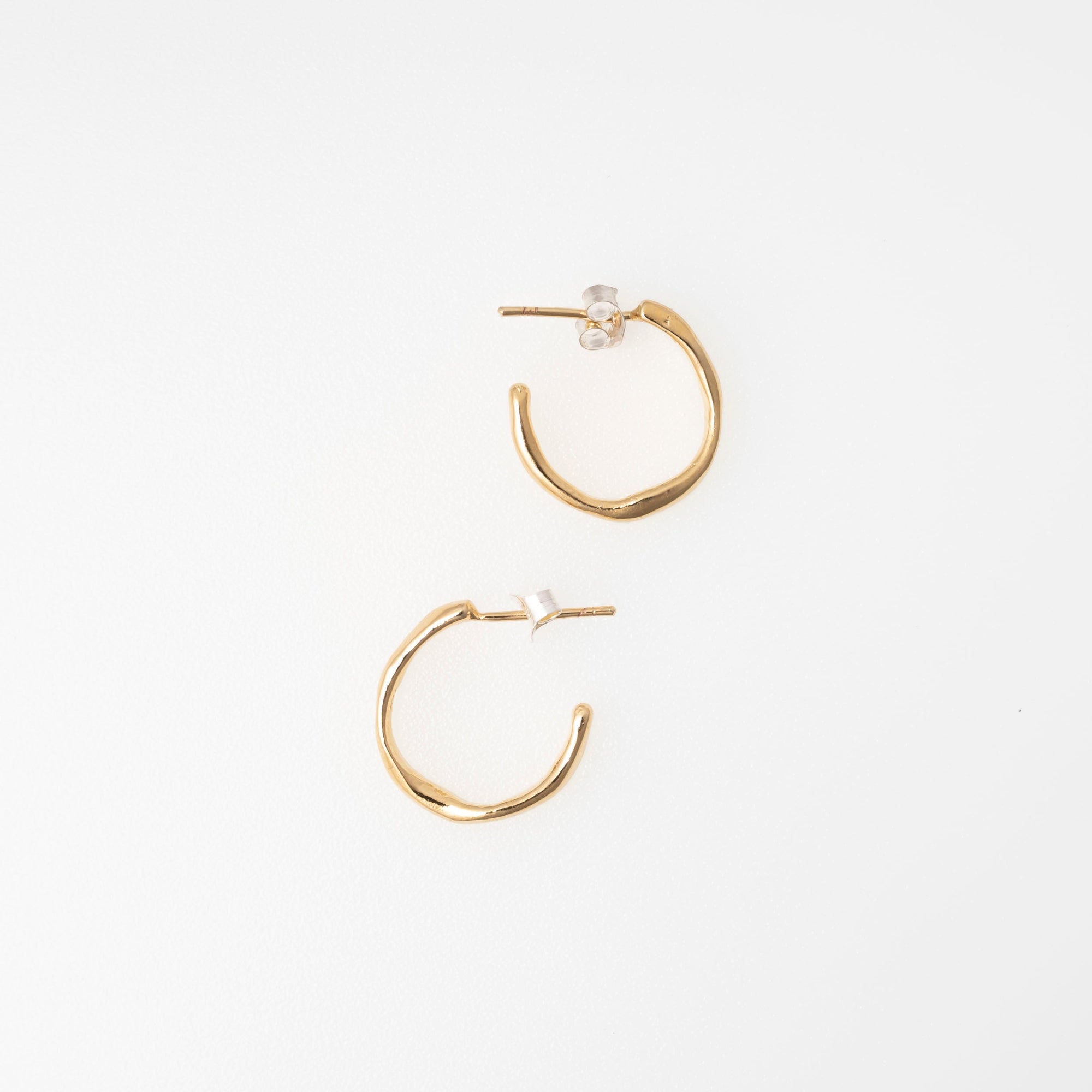 Gold hoop earrings on a white background