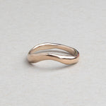 Hand-carved curved wedding band cast in solid 14k gold