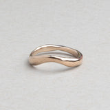 Hand-carved curved wedding band cast in solid 14k gold