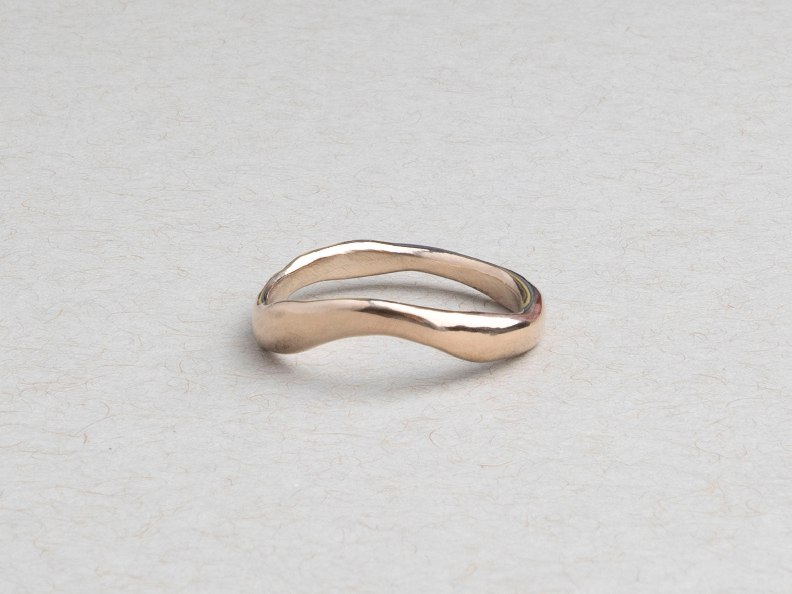 Hand-carved curved wedding band cast in solid 14k gold