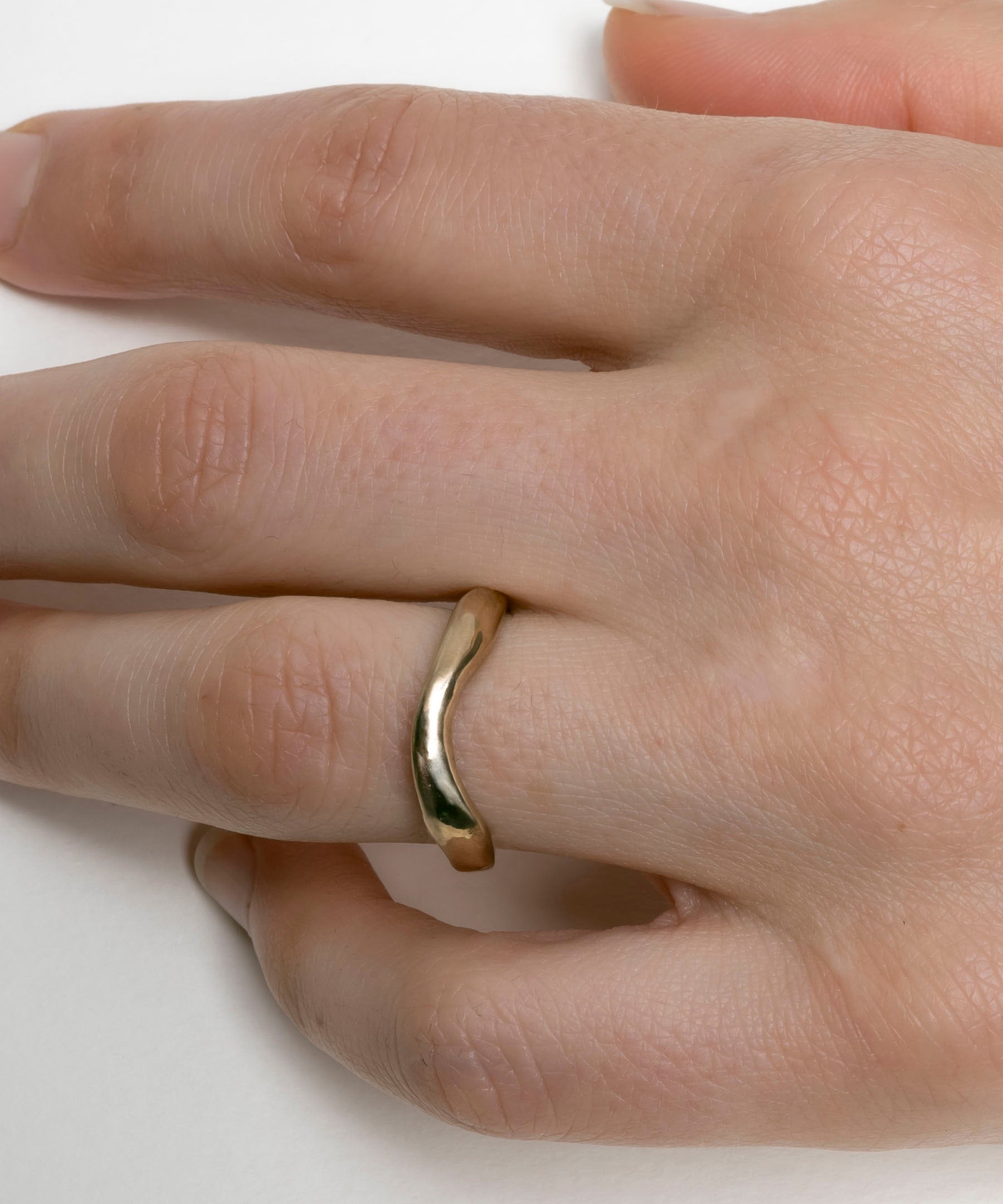 Hand-carved curved gold wedding band with organic profile