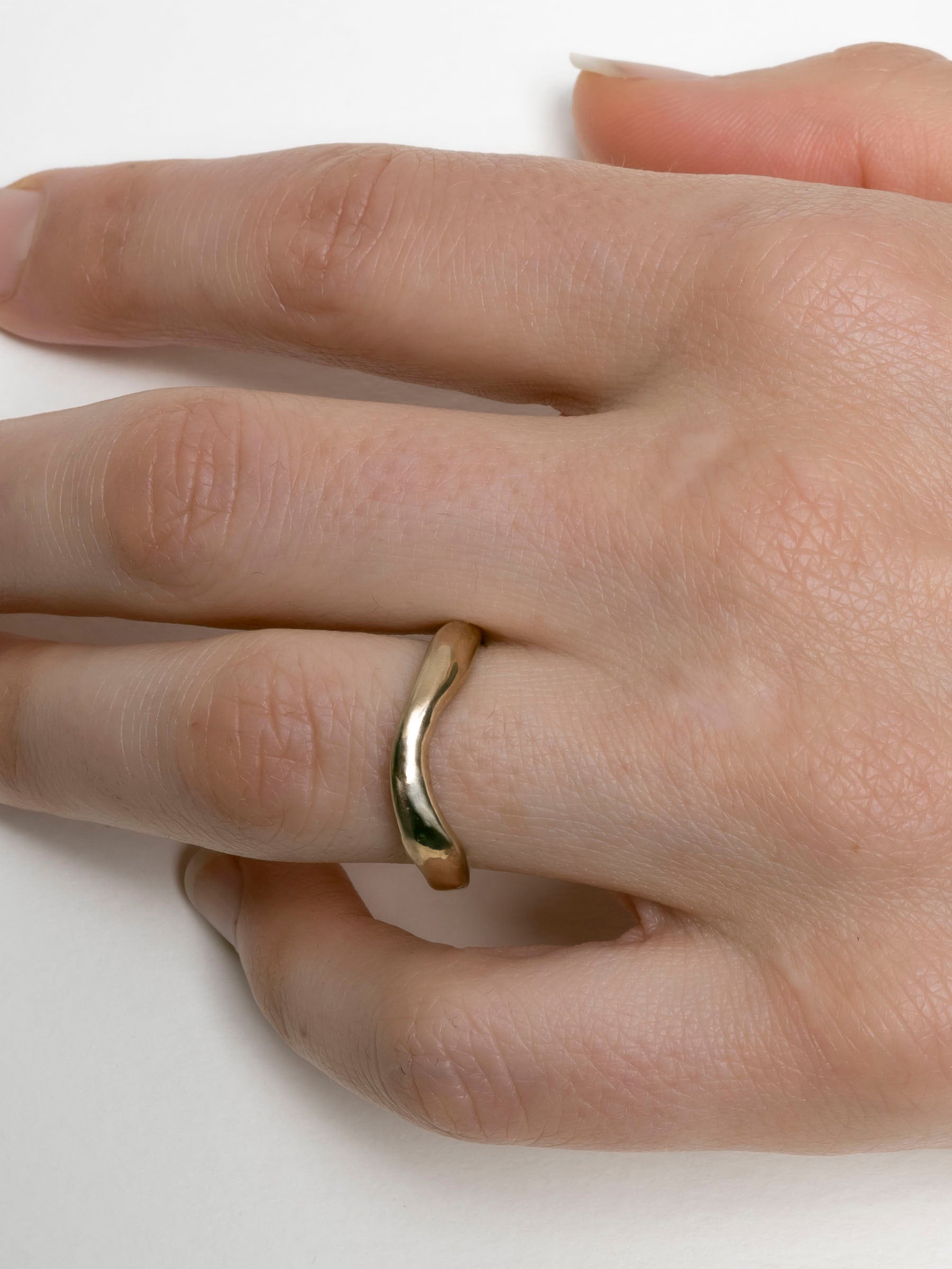 Hand-carved curved gold wedding band with organic profile