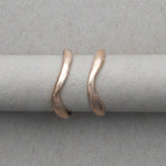 Smooth and textured curved gold wedding bands