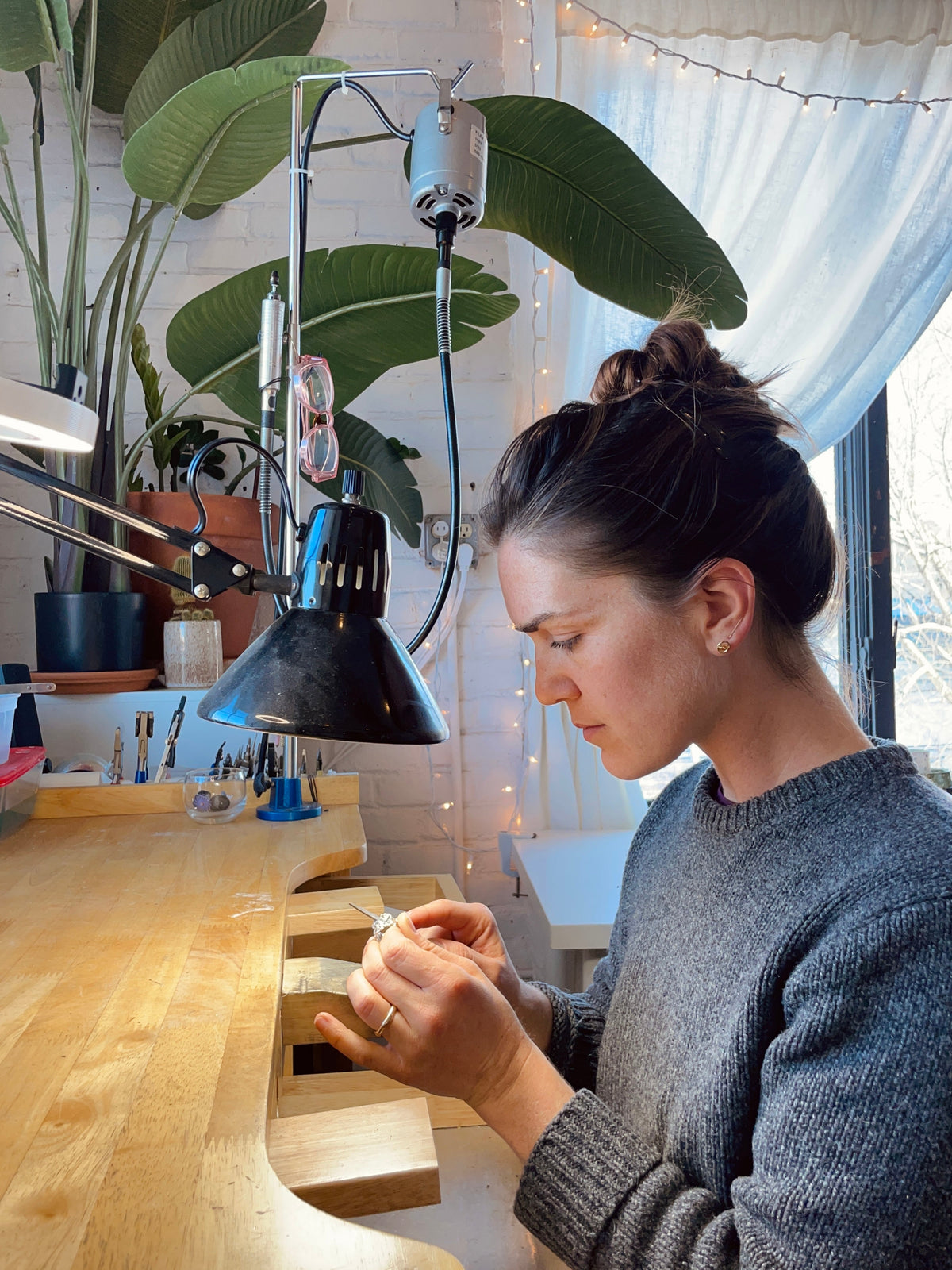 Julia Sullivan making jewelry at her workbench in the RA HA Providence studio