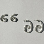 Small and large sterling silver spiral earrings shown side by side for size comparison