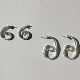 Small and large sterling silver spiral earrings shown side by side for size comparison