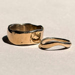 Thick and curved sculptural 14k yellow gold wedding bands shown together