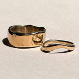 Thick and curved sculptural 14k yellow gold wedding bands shown together
