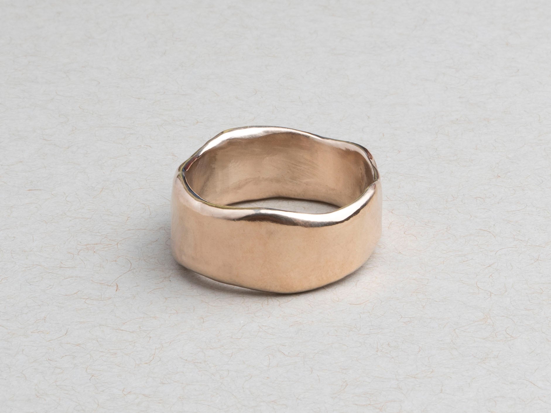 Substantial sculptural gold wedding band designed for everyday wear