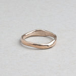 Thin hand-carved 14k gold wedding band with subtle irregular texture