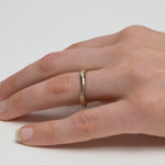 Thin 14k gold wedding band with subtle organic variation