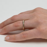 Thin 14k gold wedding band with subtle organic variation