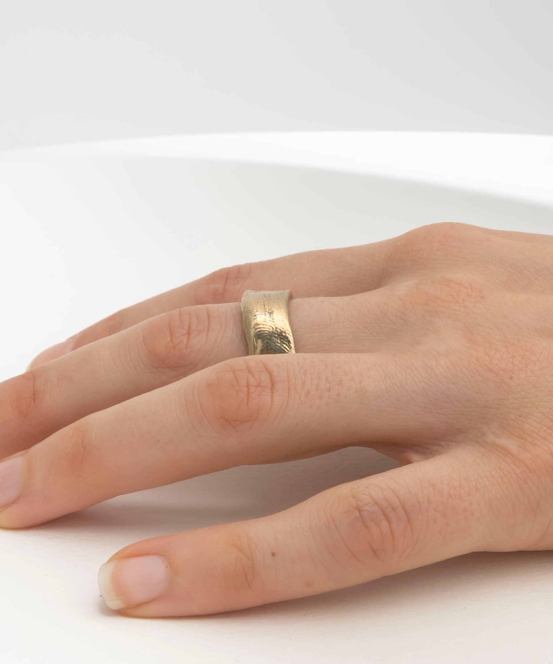 Thick hand-carved gold wedding band with textural organic finish