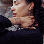 RA HA cast-link chain bracelet in sterling silver, worn on body