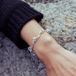 RA HA cast-link chain bracelet in sterling silver, worn on body