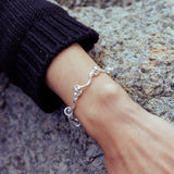 RA HA cast-link chain bracelet in sterling silver, worn on body