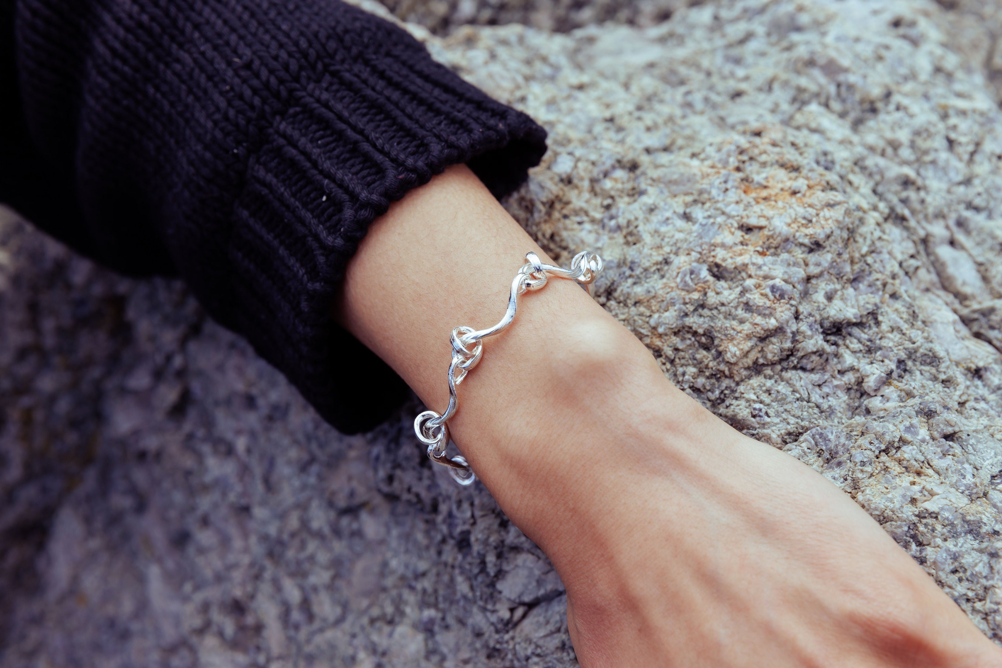 RA HA cast-link chain bracelet in sterling silver, worn on body