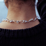RA HA cast-link chain necklace in sterling silver, worn on body detail