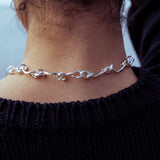 RA HA cast-link chain necklace in sterling silver, worn on body detail