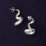 RA HA long sculptural earring in sterling silver from the Continuum collection, front view