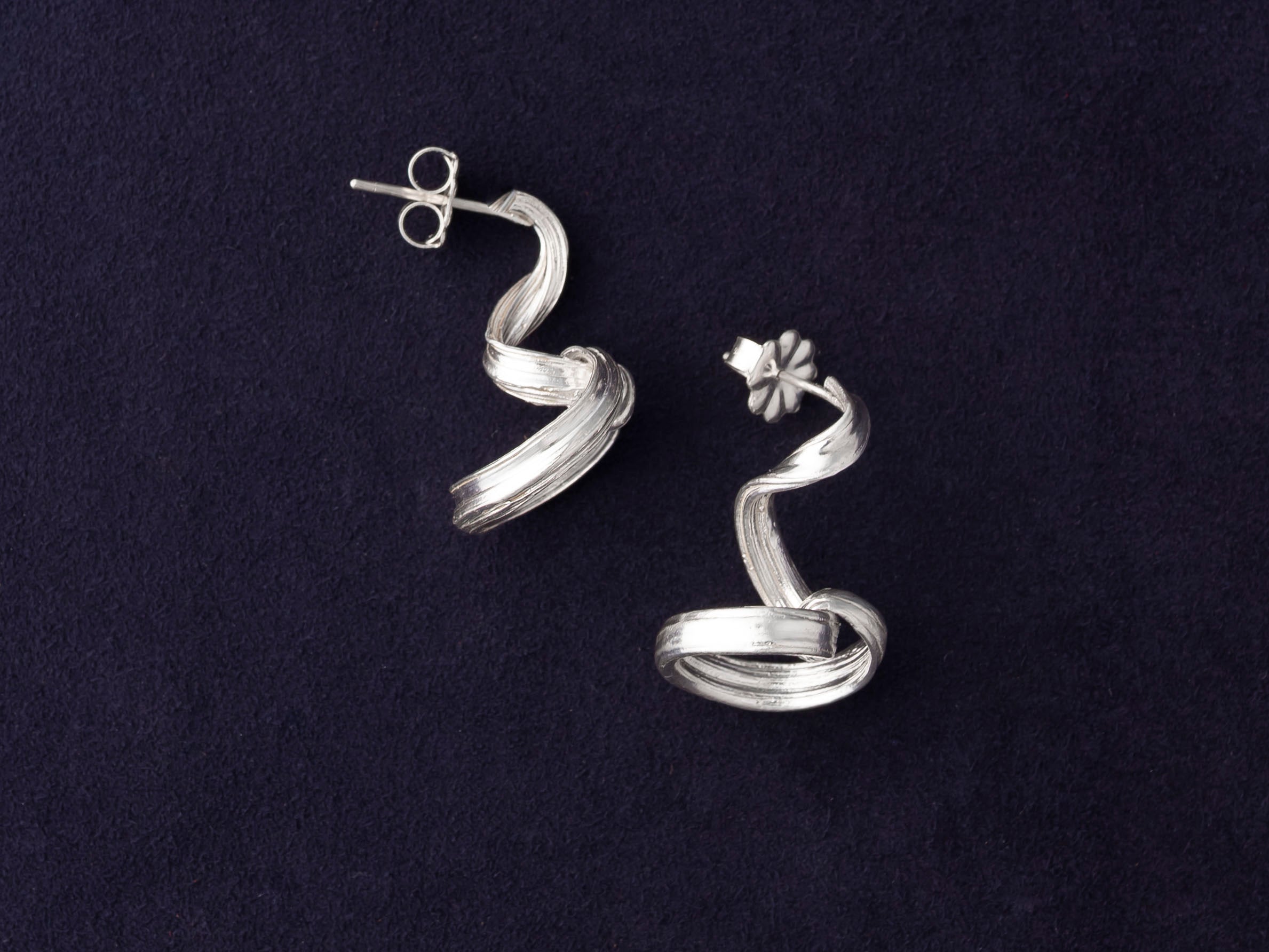 RA HA long sculptural earring in sterling silver from the Continuum collection, front view