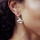 RA HA long sculptural earring in sterling silver, worn on ear