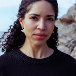 RA HA long sculptural earring in sterling silver, worn on ear
