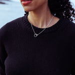 RA HA pendant necklace in sterling silver, worn on body