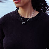 RA HA pendant necklace in sterling silver, worn on body