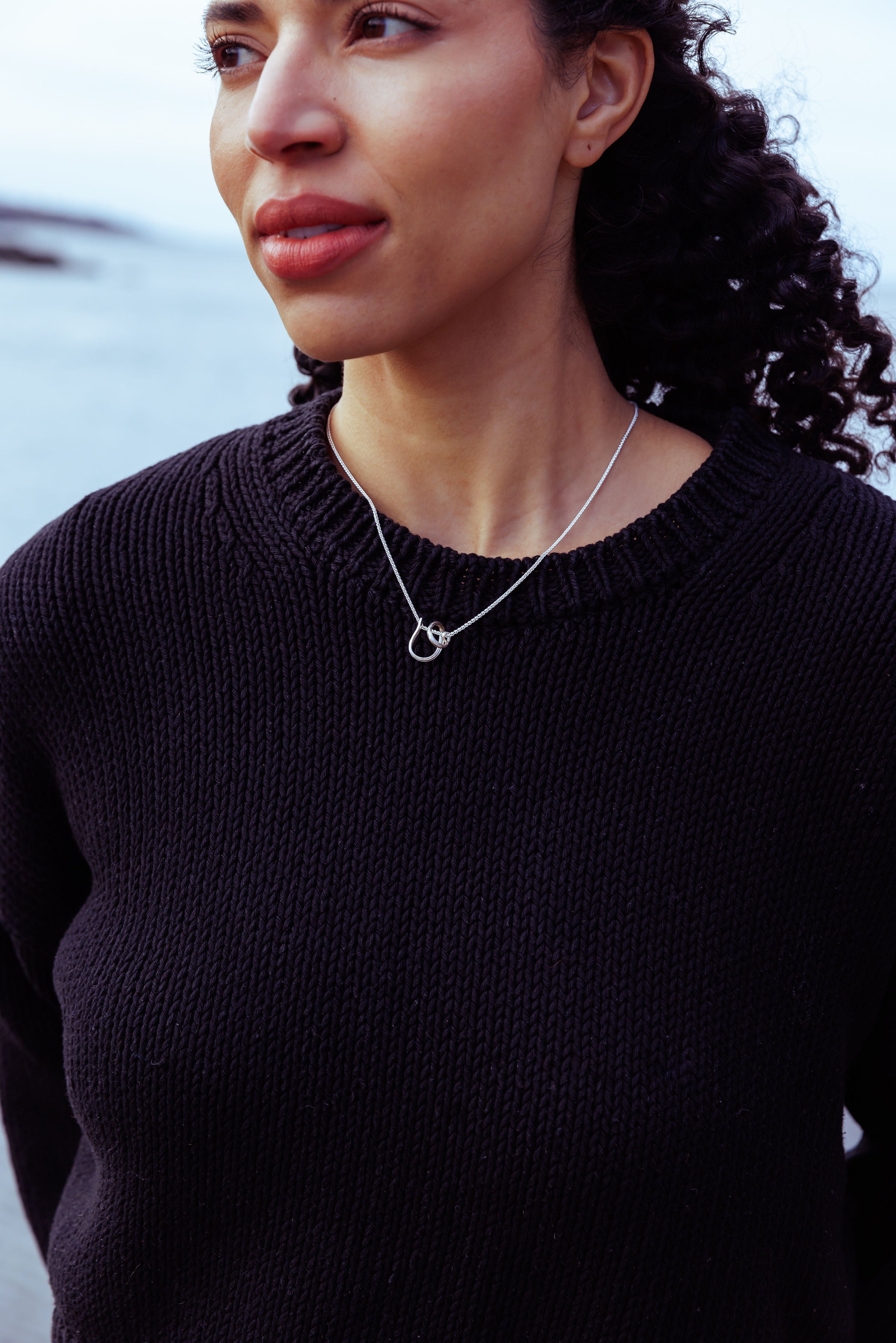 RA HA pendant necklace in sterling silver, worn on body