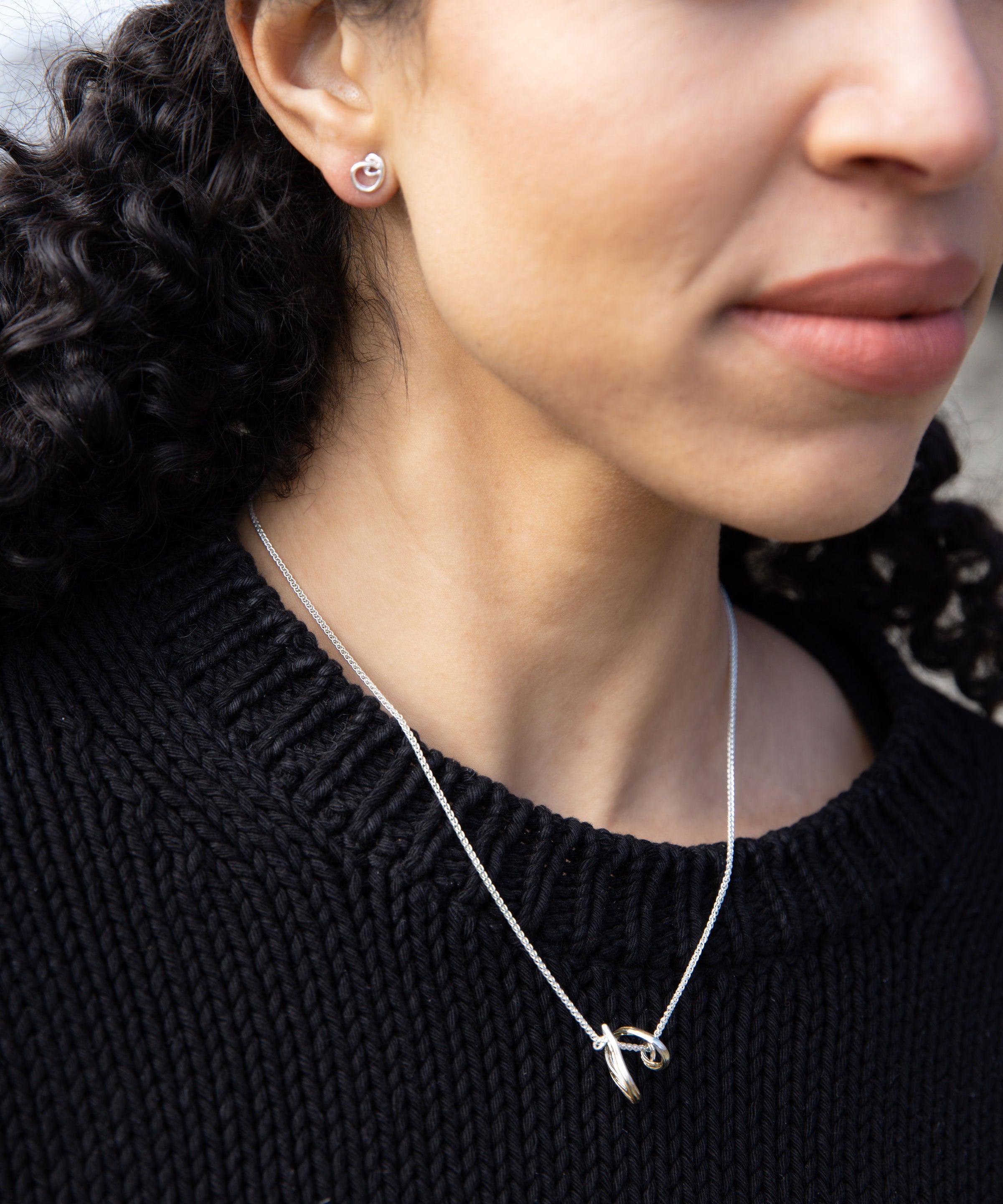 RA HA pendant necklace in sterling silver, worn on body