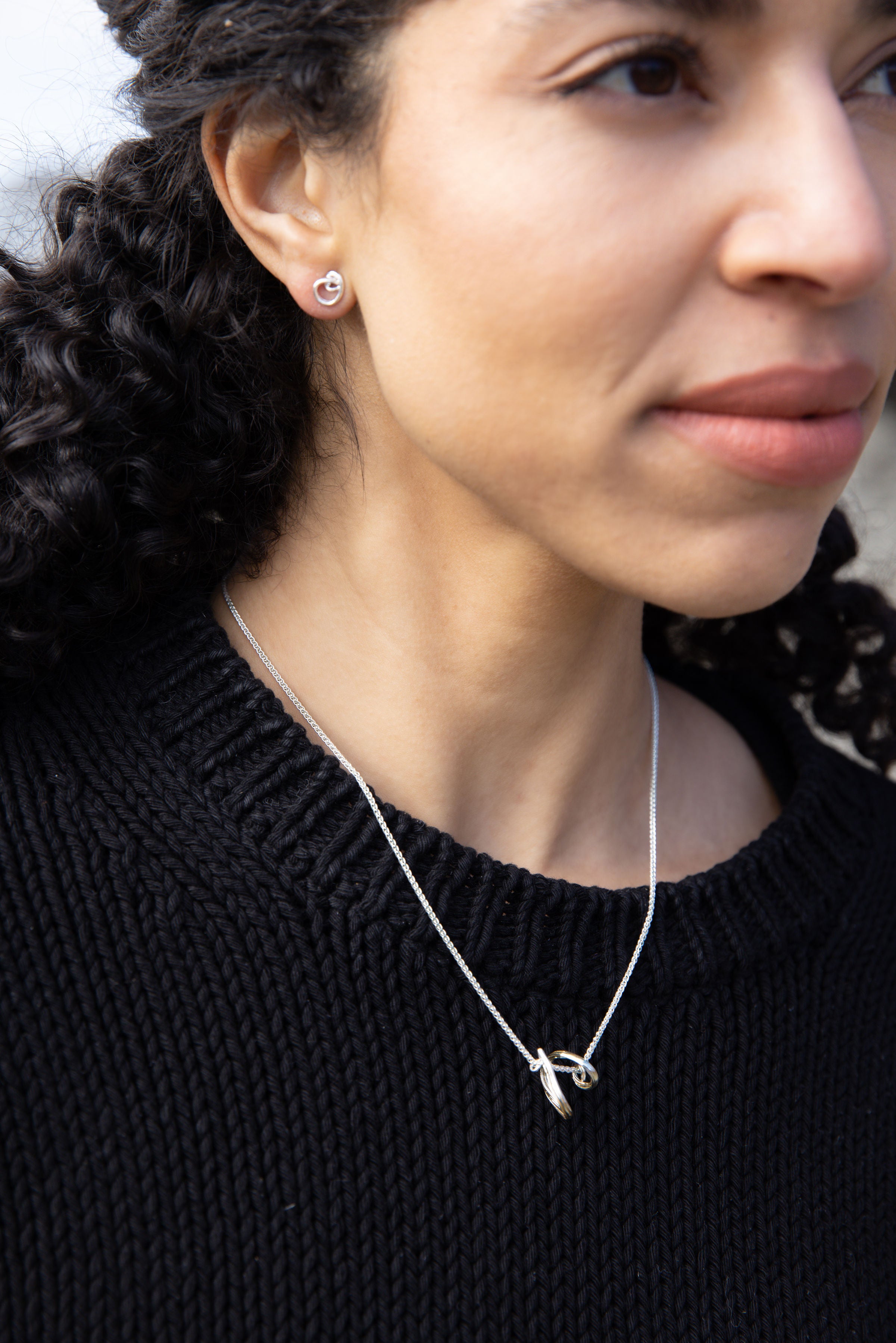 RA HA pendant necklace in sterling silver, worn on body
