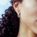 RA HA sculptural hoop earrings in sterling silver, worn on ear