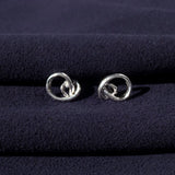 RA HA sculptural stud earrings in sterling silver from the Continuum collection, front view