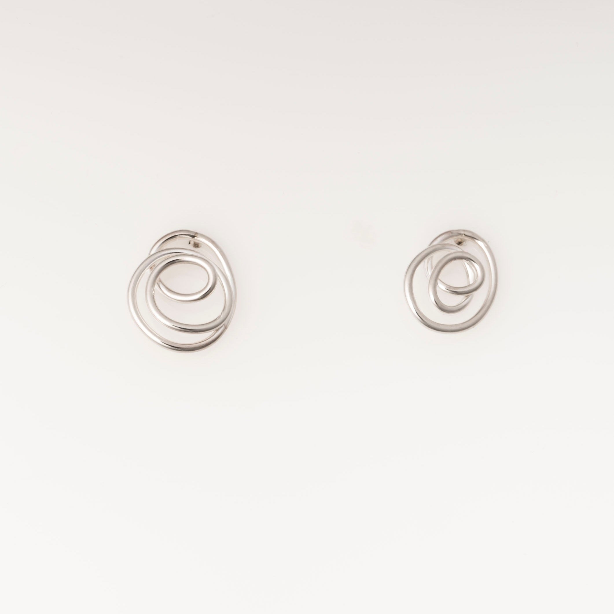 Pair of silver spiral earrings on a white background