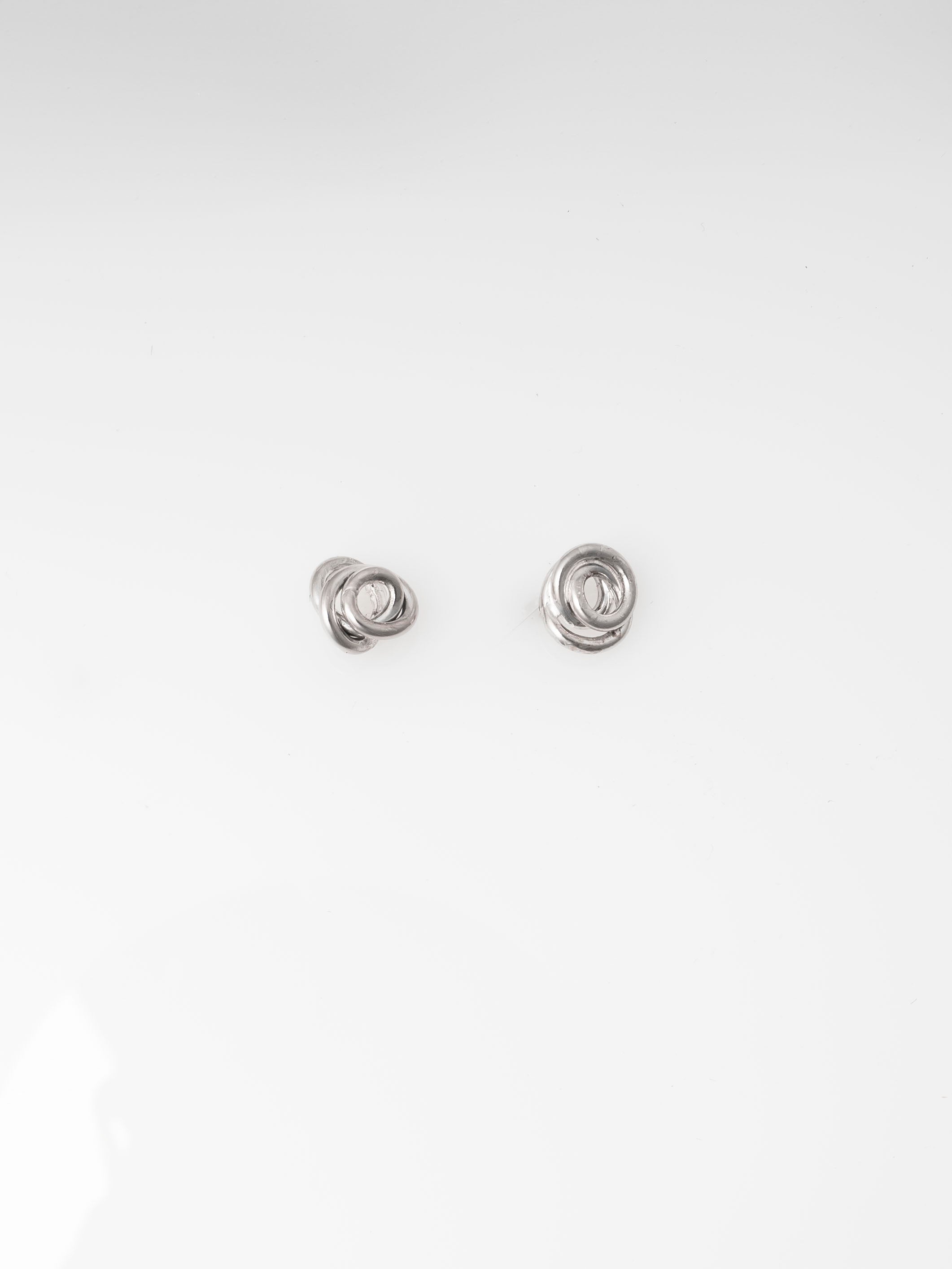 Pair of silver earrings on a white background