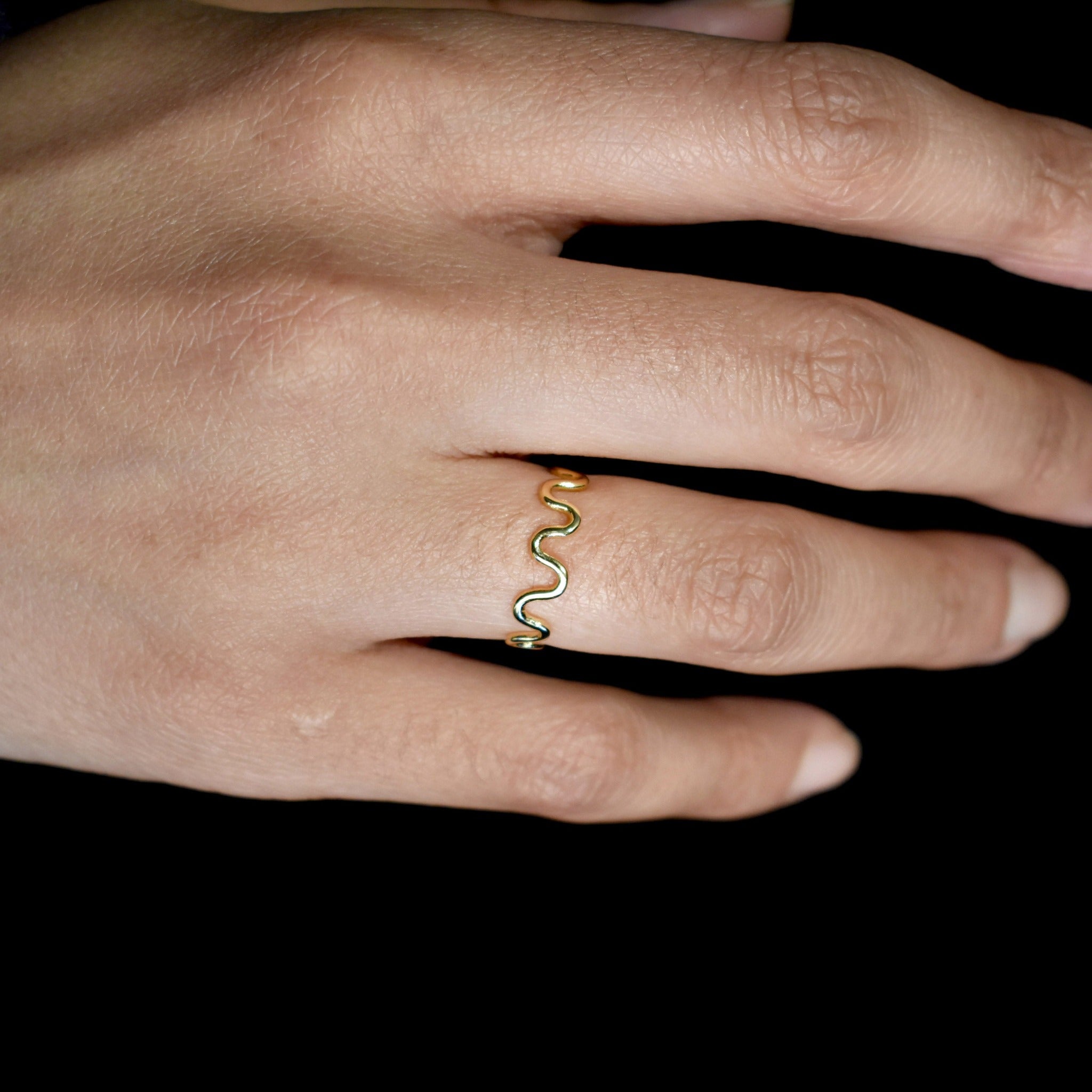 unusual Curvy gold handmade ring on hand