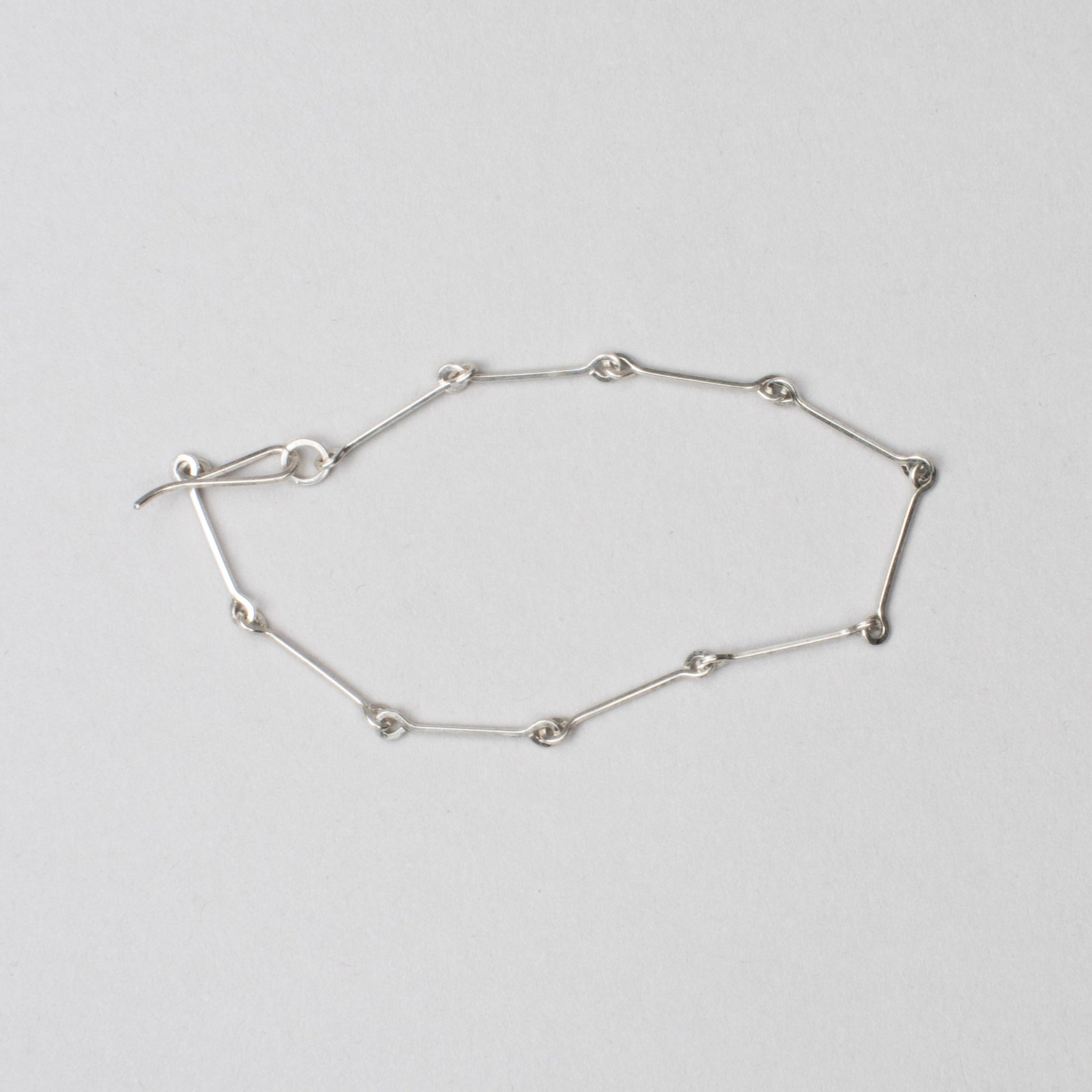 sterling silver handmade chain Bar Bracelet flat on grey background