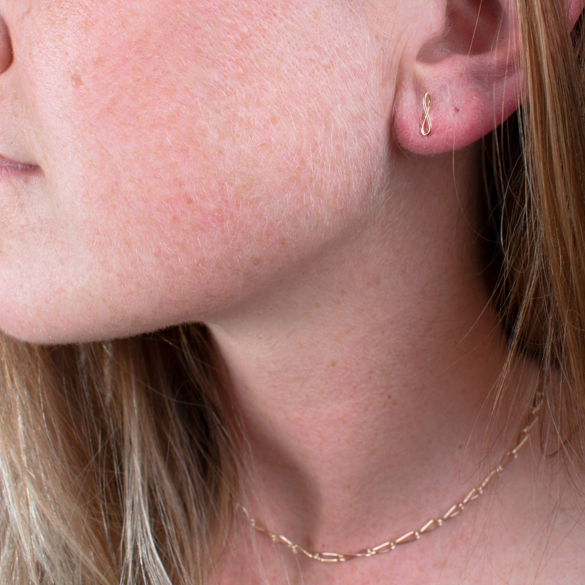 14k gold fill small mobius stud earrings on model